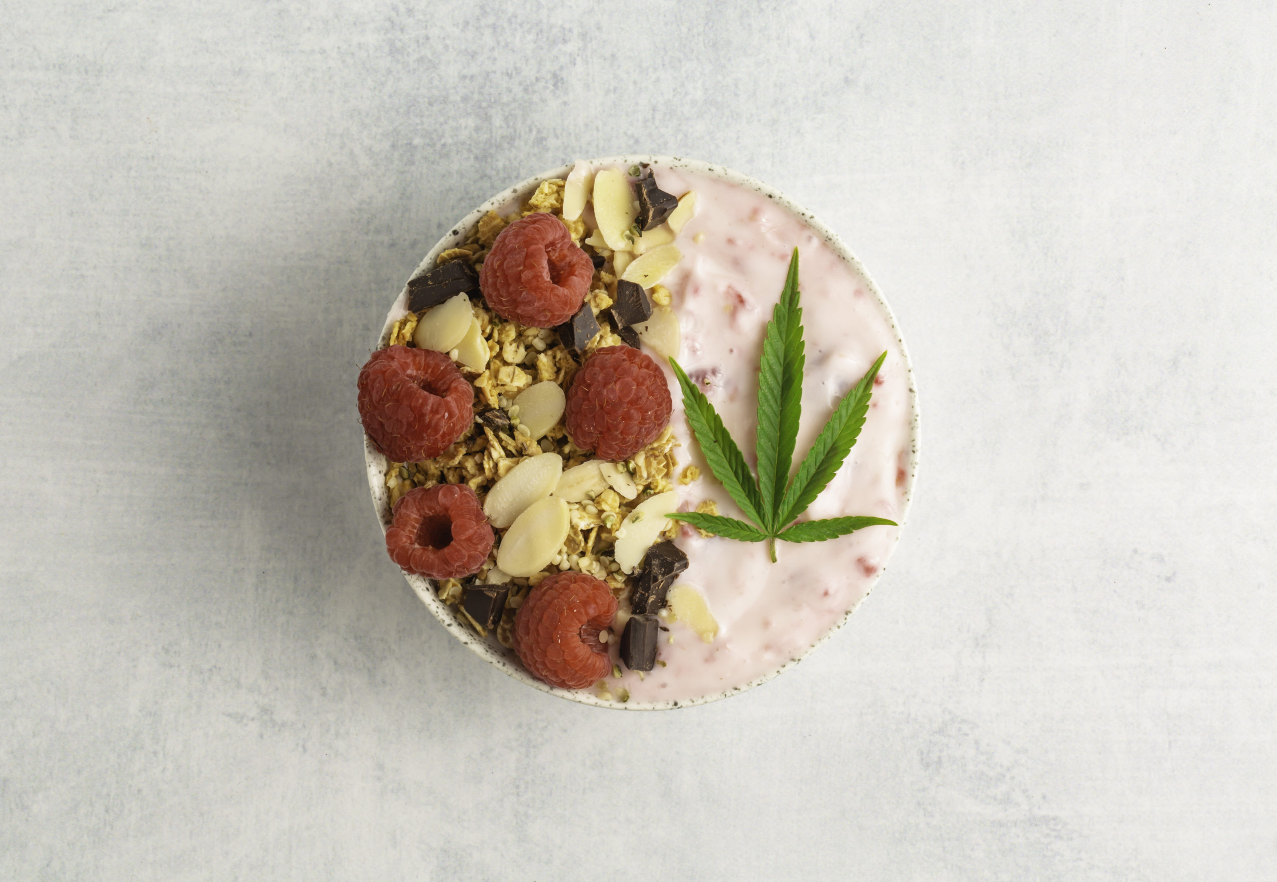 Cannabis infused fruit smoothie with CBD oil for a relaxing healthy, natural, breakfast, lunch or snack made with granola and berries