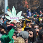 A participant holds up a sign at the 43rd annual Hash Bash rally in Ann Arbor, MI