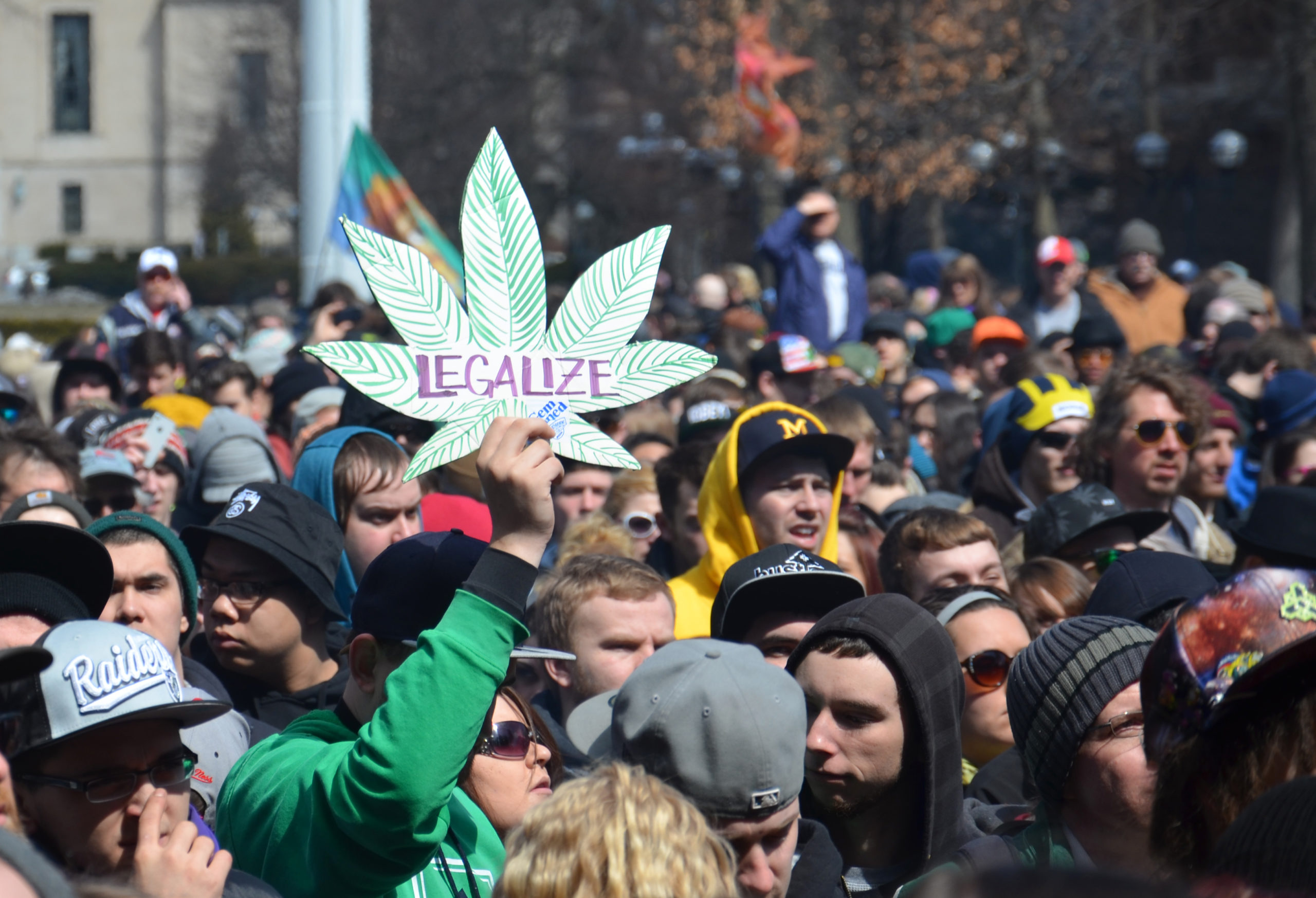 A participant holds up a sign at the 43rd annual Hash Bash rally in Ann Arbor, MI