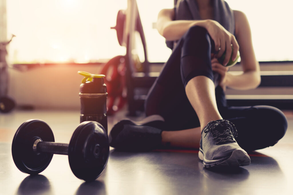 Woman exercising and recovering in gym Woman exercising and recovering in gym