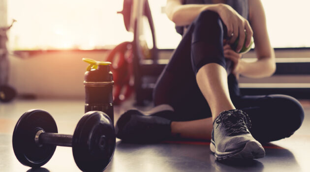 Woman exercising and recovering in gym