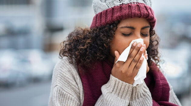 woman with cold sneezing