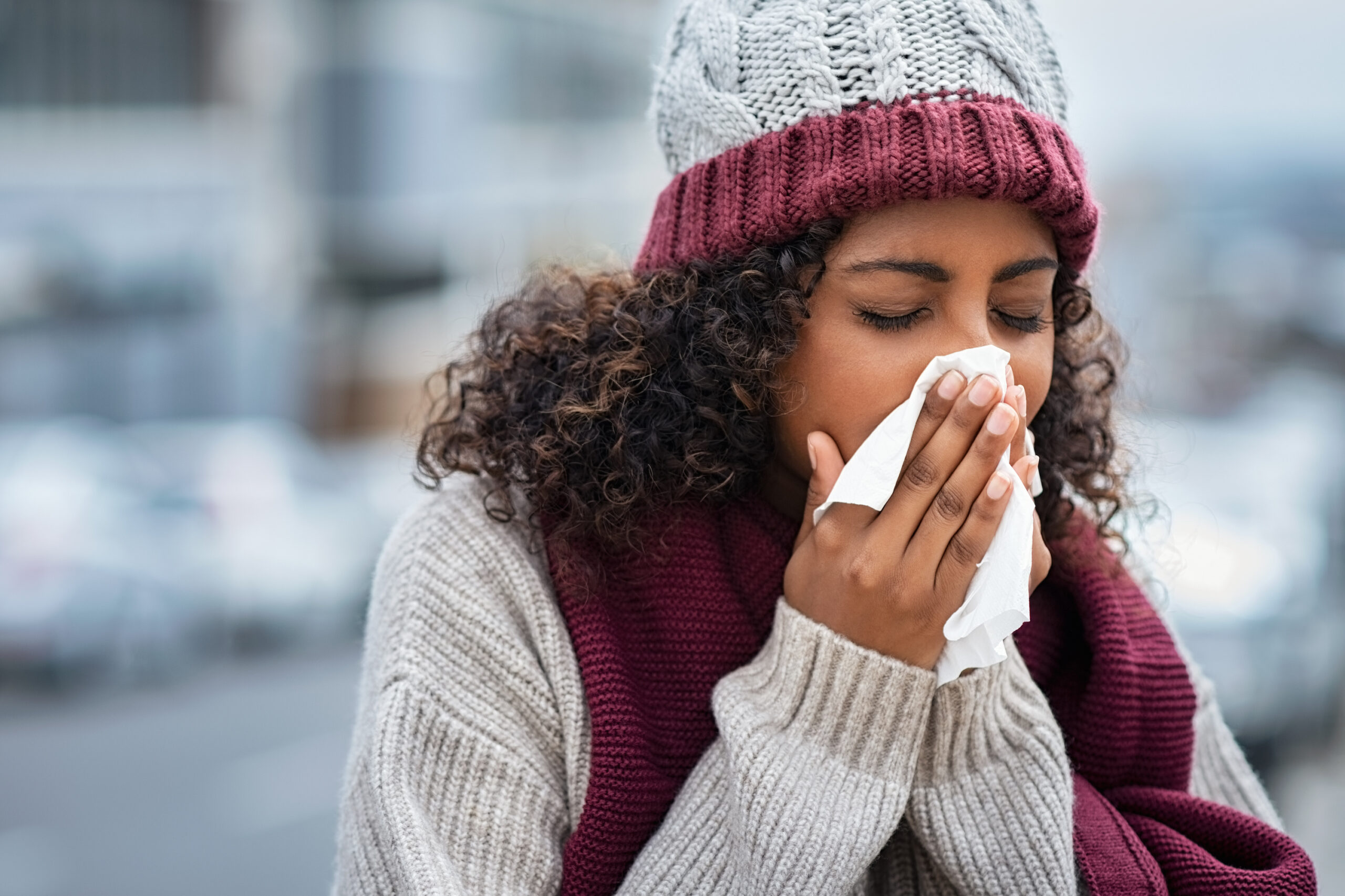 woman with cold sneezing