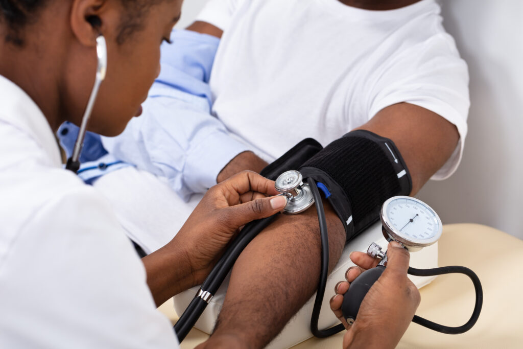 Close-up Of Doctor's Hand Measuring Blood Pressure Of cannabis Patient