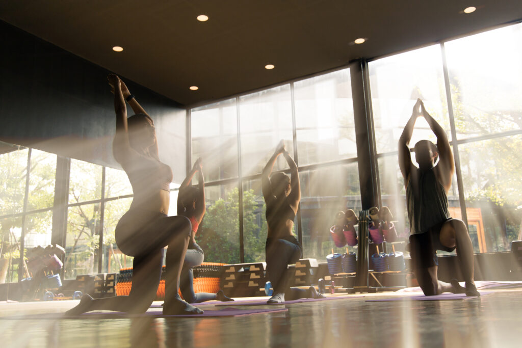 yoga group in warrior one pose.