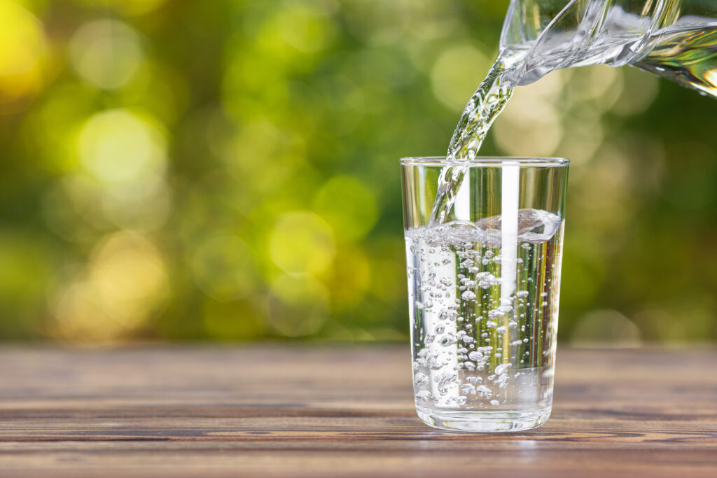 water from jug pouring into glass